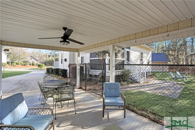 view of patio featuring ceiling fan, fence, and outdoor dining area