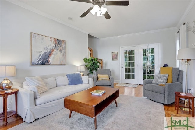 living room featuring ornamental molding, ceiling fan, and wood finished floors