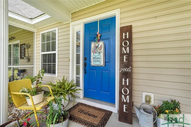 view of exterior entry featuring covered porch