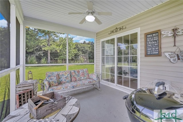 sunroom / solarium with a ceiling fan