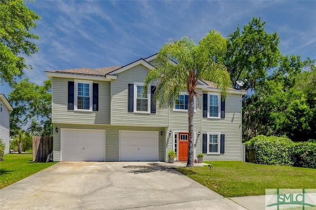 view of front of property with fence, driveway, a front yard, and a garage