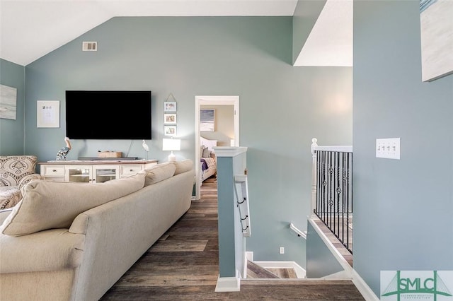 living room featuring visible vents, baseboards, dark wood-style flooring, and lofted ceiling