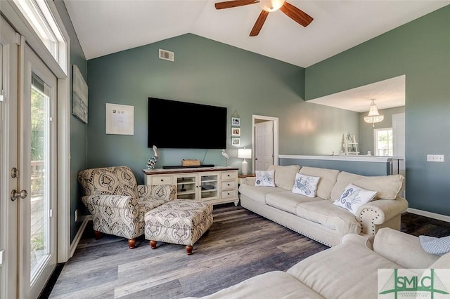 living area featuring a ceiling fan, a healthy amount of sunlight, wood finished floors, and lofted ceiling