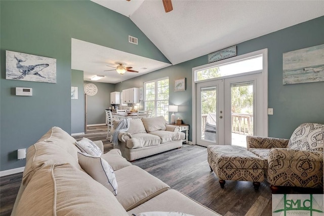 living area with french doors, vaulted ceiling, a ceiling fan, and wood finished floors