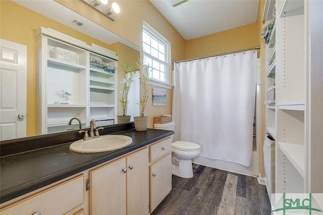 full bathroom featuring visible vents, shower / bath combo with shower curtain, vanity, wood finished floors, and toilet