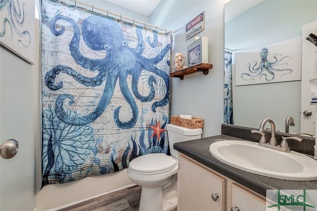 full bath with vanity, toilet, wood finished floors, and shower / tub combo