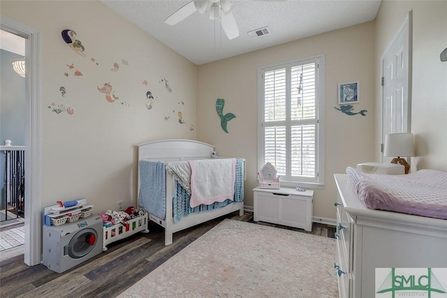bedroom featuring a textured ceiling, ceiling fan, wood finished floors, and visible vents