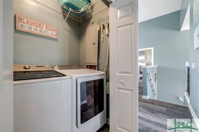 clothes washing area featuring laundry area, washer and clothes dryer, baseboards, and dark wood-style floors