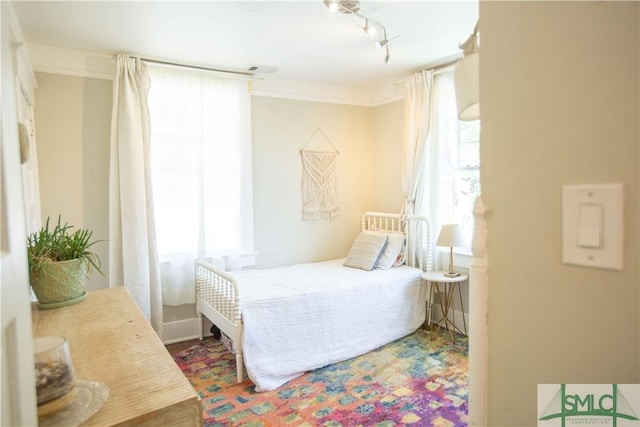 bedroom with track lighting and visible vents