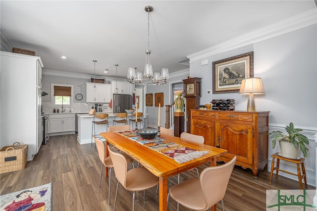 dining space with crown molding, recessed lighting, a chandelier, and dark wood-style floors