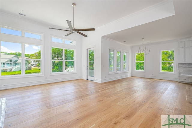 unfurnished living room with crown molding, visible vents, light wood finished floors, and ceiling fan with notable chandelier