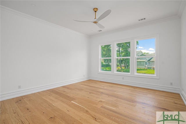 unfurnished room featuring ceiling fan, light wood finished floors, baseboards, visible vents, and ornamental molding