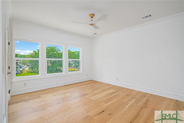 unfurnished room featuring light wood-style floors, a ceiling fan, baseboards, visible vents, and ornamental molding