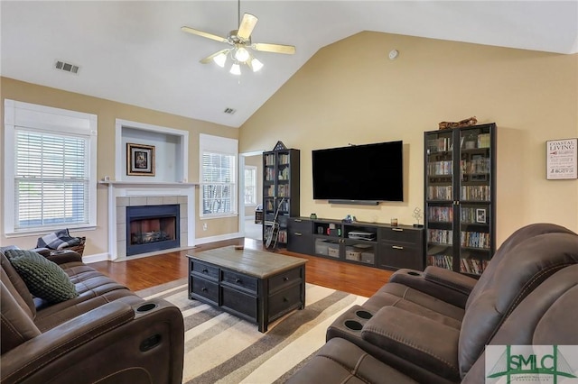 1212 Peacock Trl, Hinesville, GA 31313 - living area with ceiling fan, a fireplace, wood finished floors, and visible vents