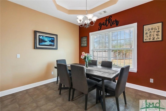 1212 Peacock Trl, Hinesville, GA 31313 - dining area featuring visible vents, baseboards, a tray ceiling, and a notable chandelier
