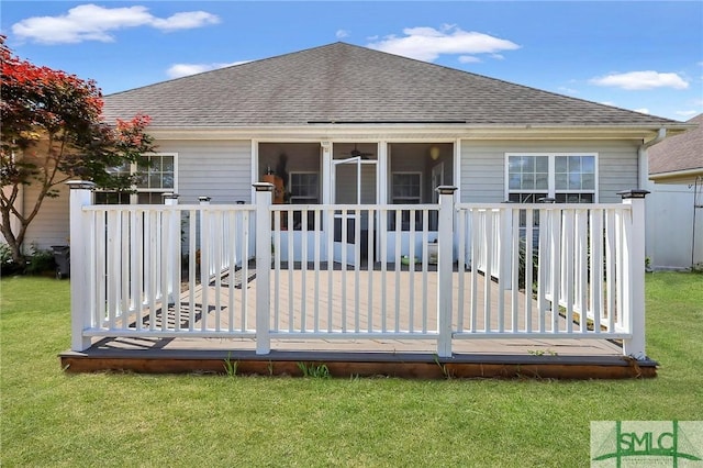 1212 Peacock Trl, Hinesville, GA 31313 - rear view of property featuring a yard, a shingled roof, a sunroom, and a deck
