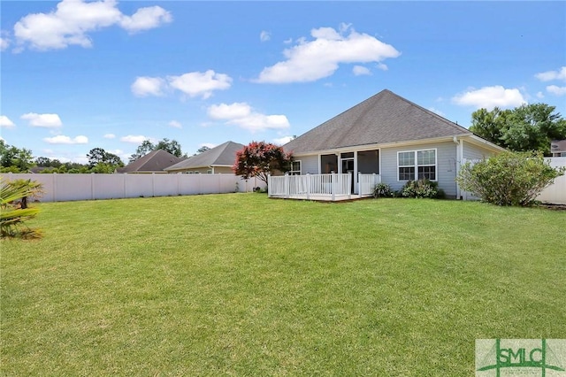 1212 Peacock Trl, Hinesville, GA 31313 - rear view of property featuring a lawn, a wooden deck, a fenced backyard, and a sunroom
