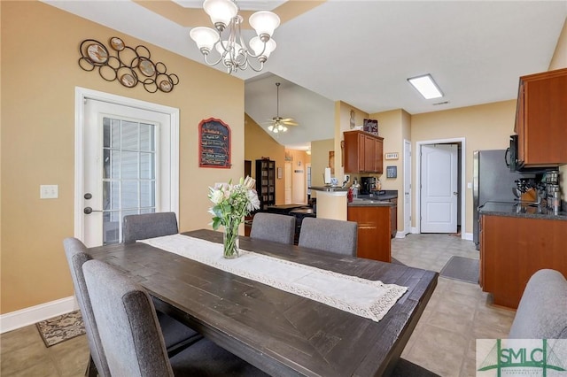1212 Peacock Trl, Hinesville, GA 31313 - dining room featuring baseboards, vaulted ceiling, and ceiling fan with notable chandelier