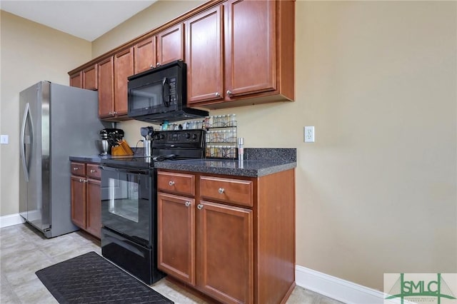 1212 Peacock Trl, Hinesville, GA 31313 - kitchen with baseboards, dark stone countertops, brown cabinets, and black appliances
