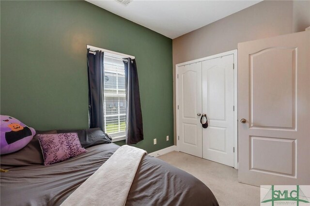 1212 Peacock Trl, Hinesville, GA 31313 - bedroom featuring light colored carpet, baseboards, and a closet