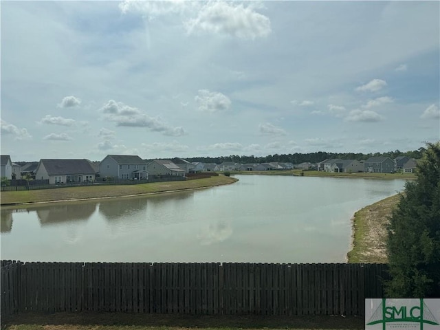 property view of water with fence and a residential view
