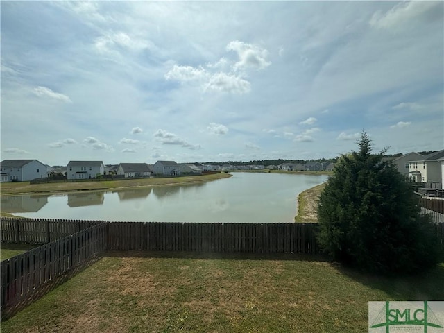 property view of water featuring a fenced backyard and a residential view