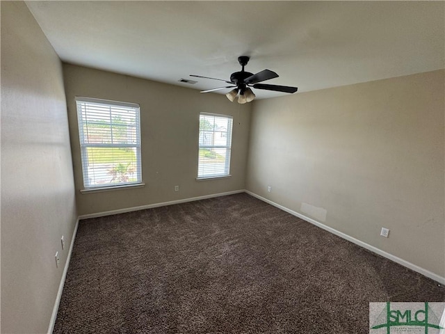 unfurnished room with carpet floors, ceiling fan, visible vents, and baseboards