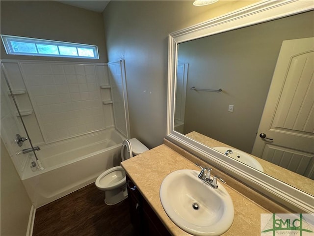 bathroom with vanity, toilet, wood finished floors, and  shower combination