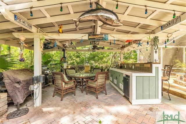 view of patio featuring area for grilling, a gazebo, and outdoor dining space