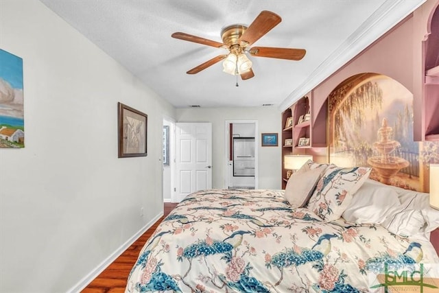 bedroom with dark wood-type flooring, a ceiling fan, and baseboards