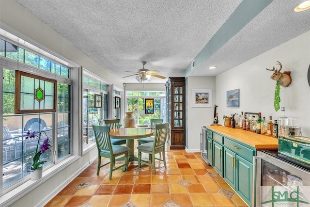 interior space featuring wine cooler, visible vents, and a healthy amount of sunlight