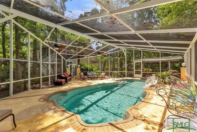 outdoor pool featuring an outdoor living space, glass enclosure, and a patio area