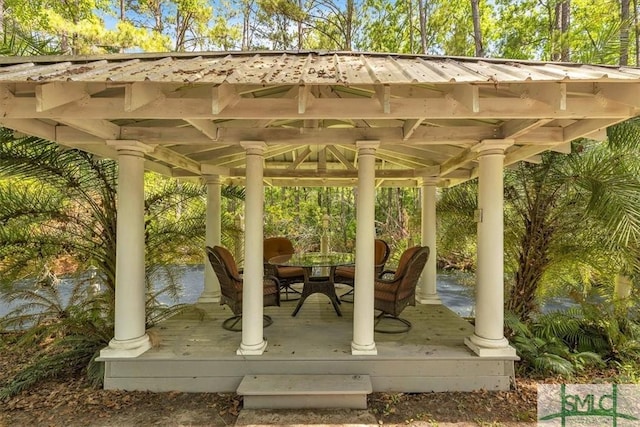 view of patio / terrace with a gazebo, a wooden deck, and outdoor dining space