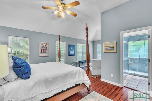 bedroom with ceiling fan, baseboards, wood finished floors, lofted ceiling, and ensuite bathroom
