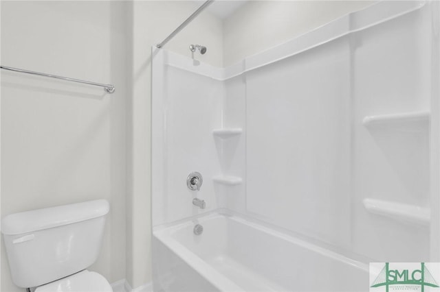 bathroom featuring washtub / shower combination and toilet