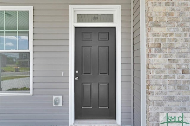 entrance to property with brick siding