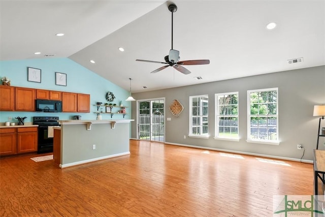 76 Hamilton Grove Dr, Pooler, GA 31322 - kitchen featuring visible vents, brown cabinetry, open floor plan, light countertops, and black appliances