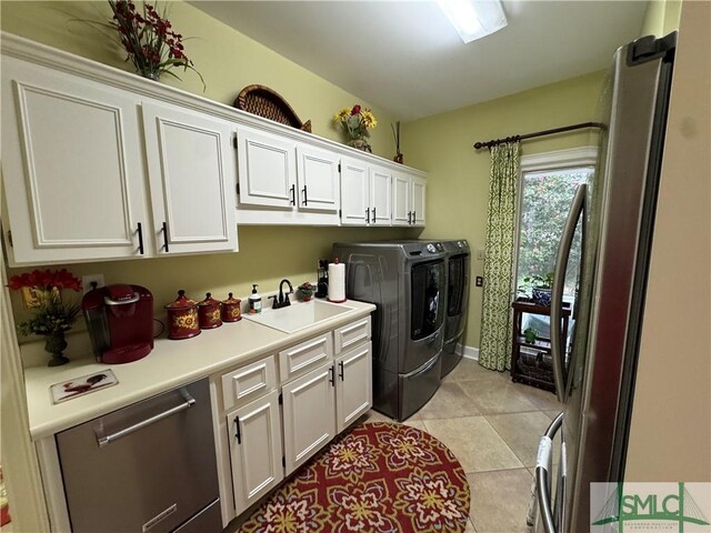 31 Sweetgum Xing, Savannah, GA 31411 - laundry area featuring independent washer and dryer, cabinet space, and light tile patterned floors