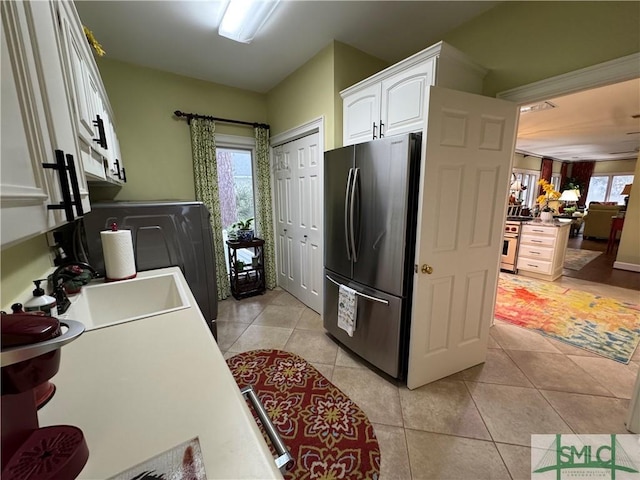 laundry area featuring a sink and light tile patterned floors