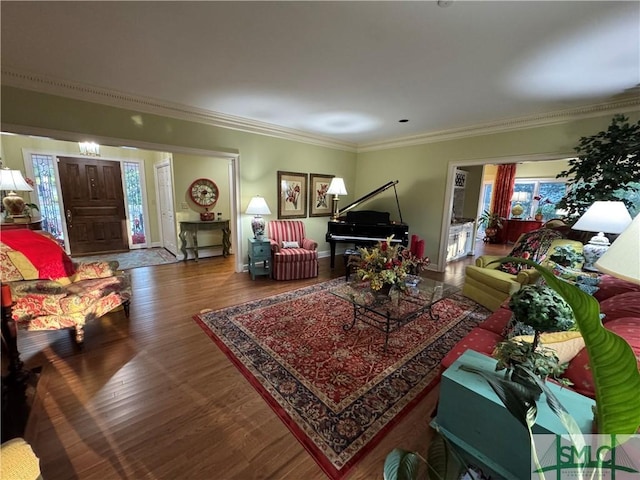 living room featuring baseboards, ornamental molding, and wood finished floors