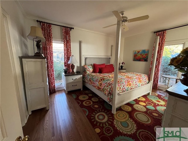 bedroom featuring crown molding, dark wood-style floors, and a ceiling fan