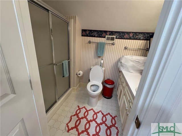 bathroom featuring a stall shower, toilet, visible vents, tile patterned floors, and vanity