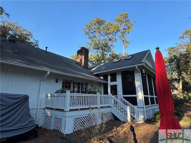 31 Sweetgum Xing, Savannah, GA 31411 - rear view of property featuring a chimney, a wooden deck, a sunroom, and a shingled roof