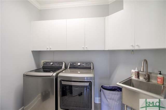 laundry room with cabinet space, a sink, separate washer and dryer, baseboards, and ornamental molding