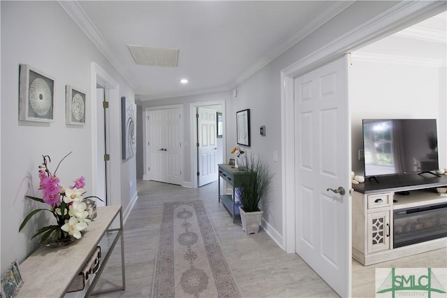 hallway featuring recessed lighting, ornamental molding, light wood-type flooring, and visible vents