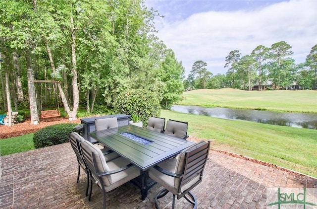 view of patio / terrace with outdoor dining space, a water view, and view of golf course