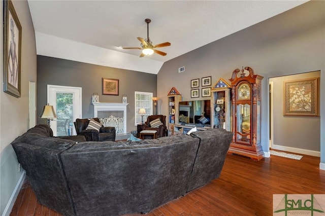 living area featuring baseboards, a ceiling fan, wood finished floors, and visible vents