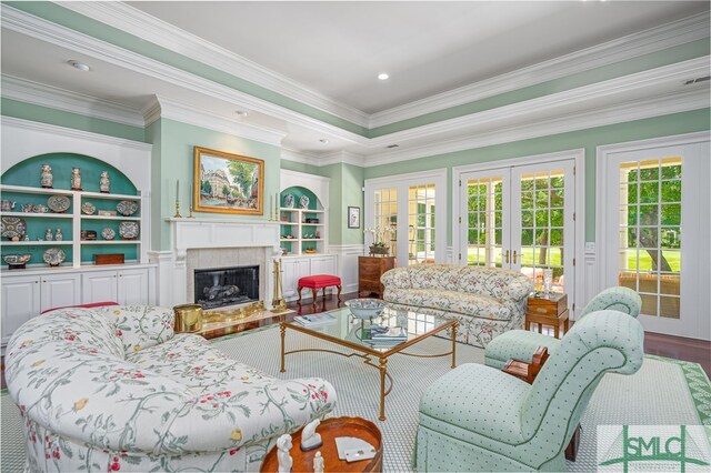 living room featuring french doors, a fireplace with raised hearth, a decorative wall, and a wealth of natural light