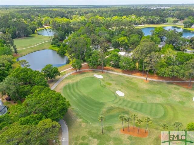 birds eye view of property with a water view and golf course view
