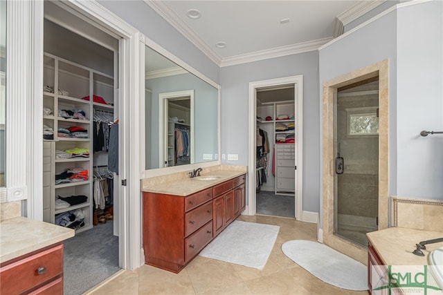 bathroom featuring vanity, ornamental molding, a stall shower, and tile patterned flooring